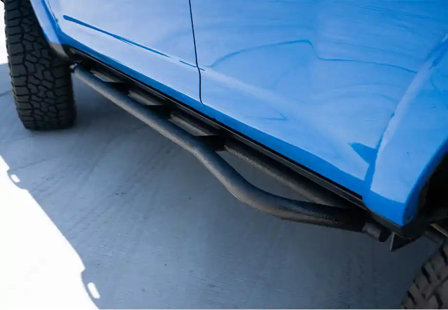 Cali Raised LED Trail Edition Rock Sliders on a rocky trail